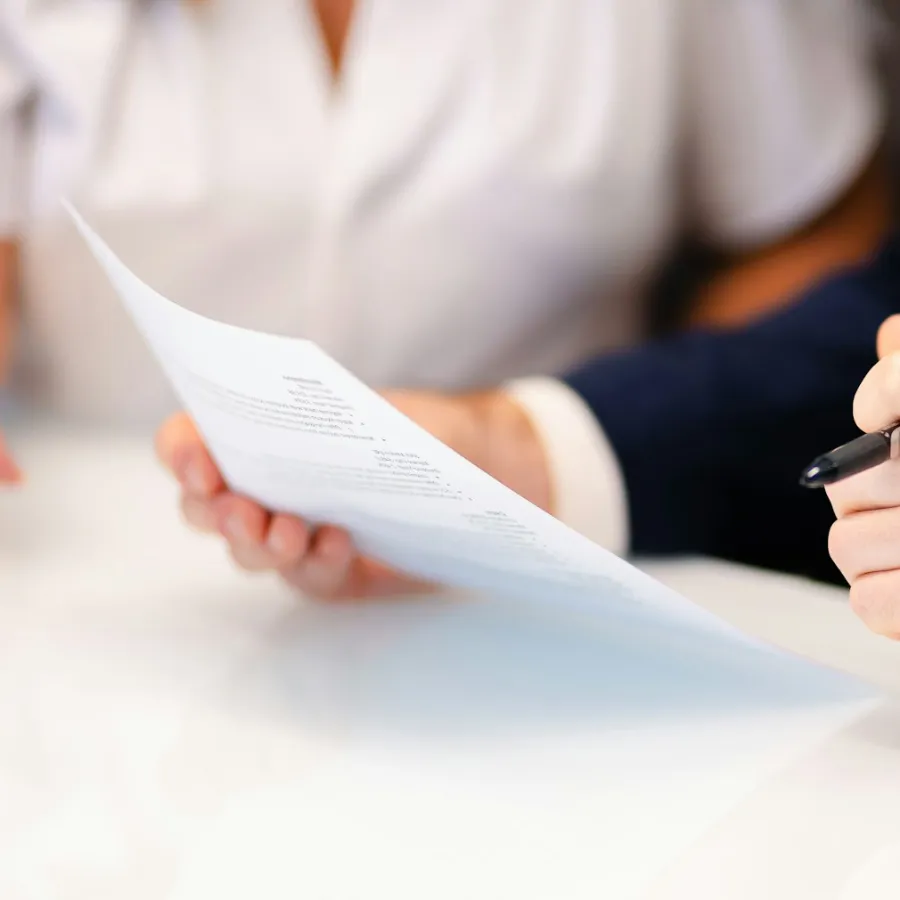 An operator reading a printed policy document